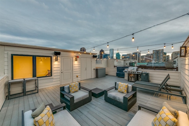 wooden terrace featuring an outdoor hangout area and a view of city