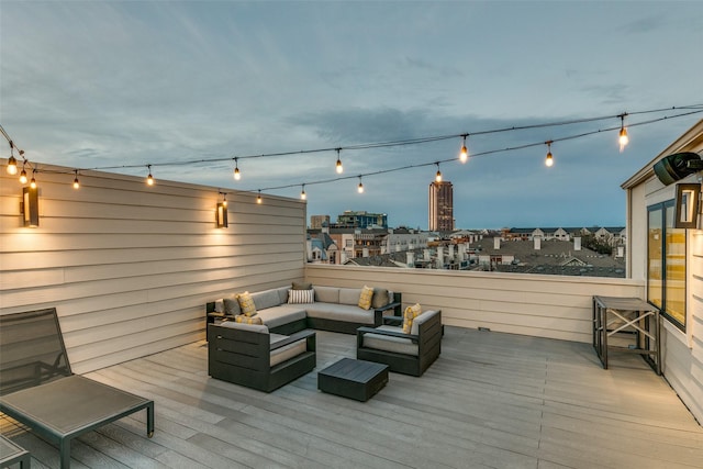 deck featuring a city view and an outdoor hangout area