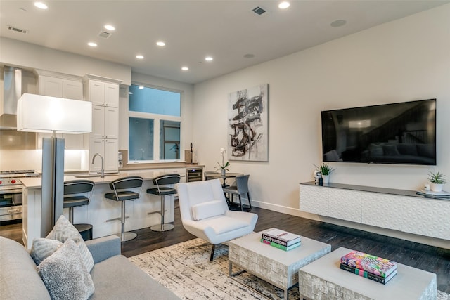 living room with recessed lighting, visible vents, and dark wood-style floors