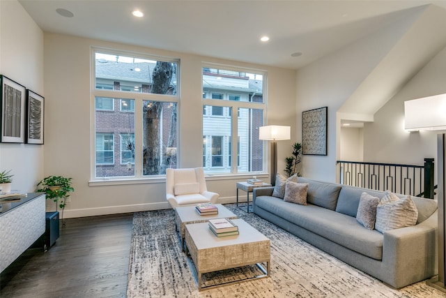 living area featuring recessed lighting, baseboards, and dark wood-style flooring