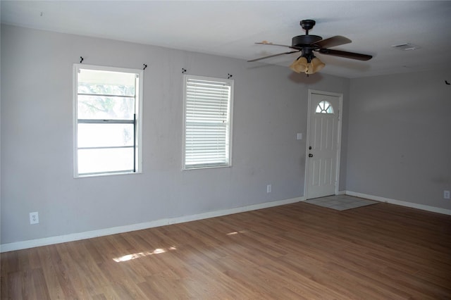 entrance foyer with visible vents, a ceiling fan, light wood-type flooring, and baseboards