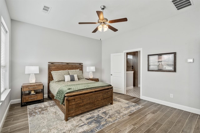 bedroom featuring wood finish floors, visible vents, baseboards, and a ceiling fan