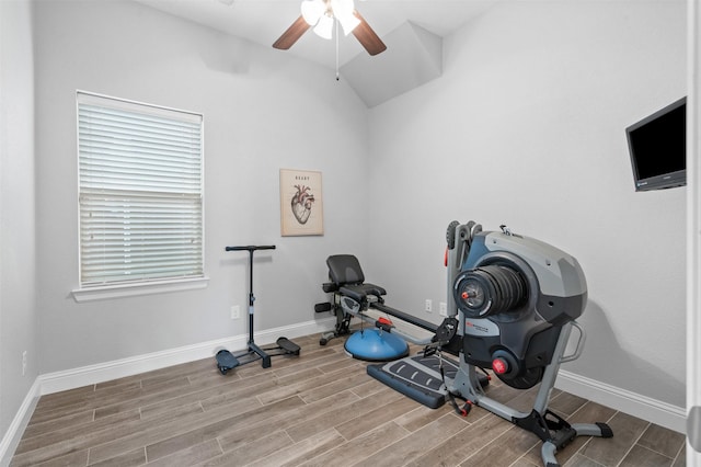 workout area with ceiling fan, vaulted ceiling, baseboards, and wood finish floors