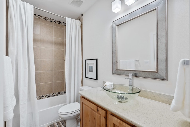 full bathroom with visible vents, toilet, vanity, and shower / bath combination with curtain