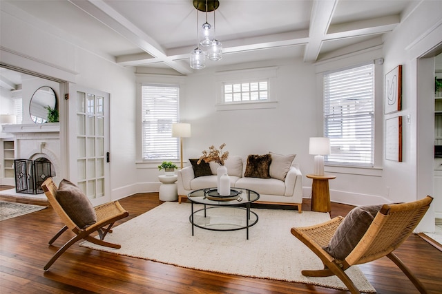 living room featuring hardwood / wood-style floors, baseboards, coffered ceiling, beam ceiling, and a brick fireplace