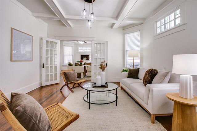 living room featuring beamed ceiling, wood finished floors, baseboards, and coffered ceiling