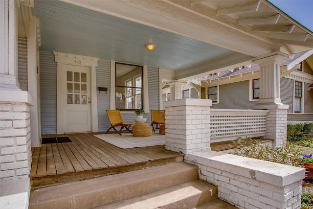 view of exterior entry with a porch