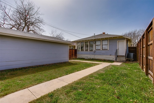 exterior space featuring crawl space, entry steps, a yard, and fence