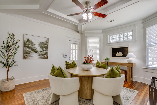 dining space featuring wood finished floors, visible vents, and baseboards