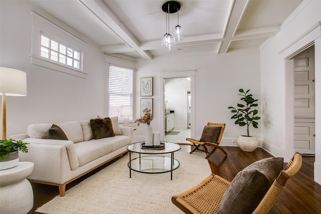 living room featuring beam ceiling, coffered ceiling, baseboards, and wood finished floors