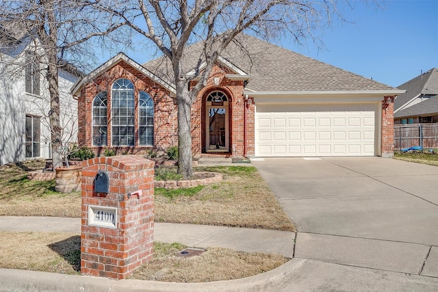 view of front of property with brick siding, a shingled roof, fence, concrete driveway, and a garage