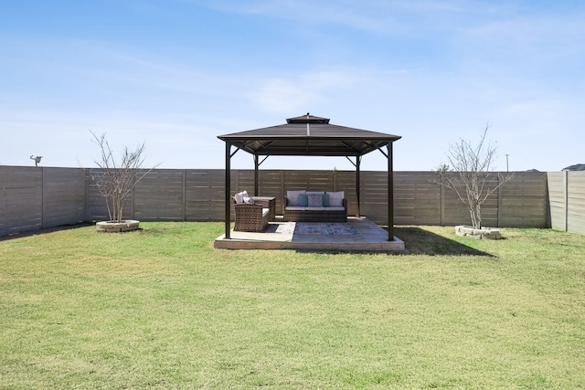 view of yard featuring a gazebo, an outdoor living space, and a fenced backyard