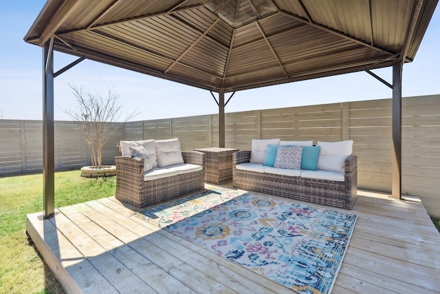 wooden deck featuring a gazebo, an outdoor living space, and a fenced backyard