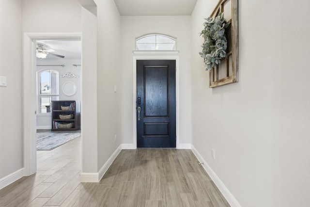 entrance foyer with wood finished floors, baseboards, and ceiling fan