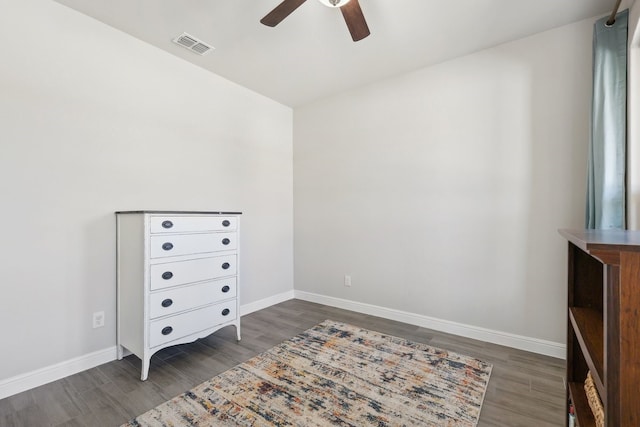 unfurnished bedroom with a ceiling fan, wood finished floors, visible vents, and baseboards