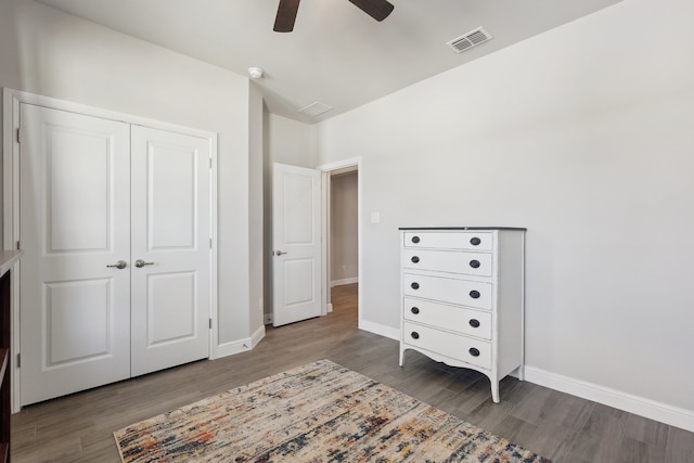 unfurnished bedroom with visible vents, baseboards, a closet, and wood finished floors