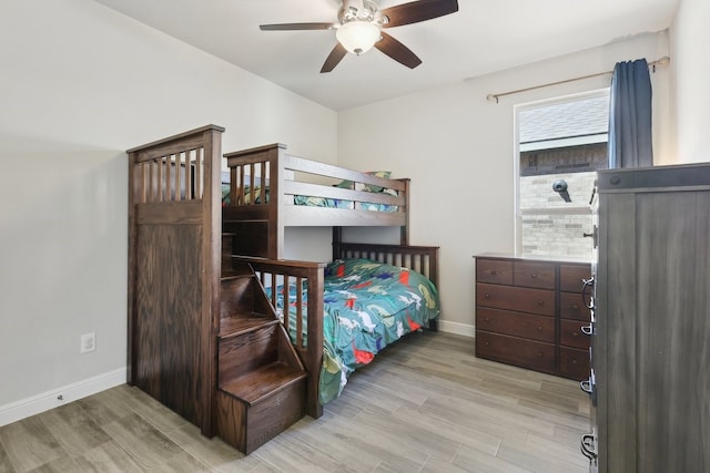 bedroom featuring ceiling fan, baseboards, and light wood-style flooring