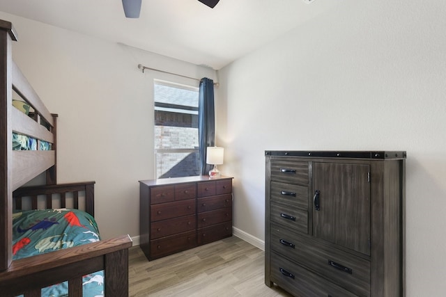 bedroom featuring ceiling fan, baseboards, and light wood-style floors