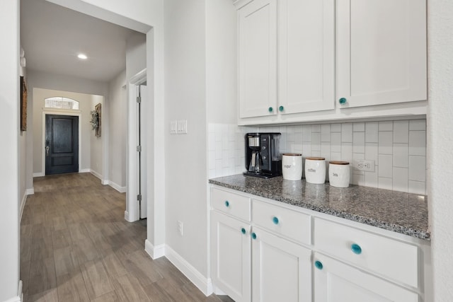 interior space with baseboards and wood finished floors