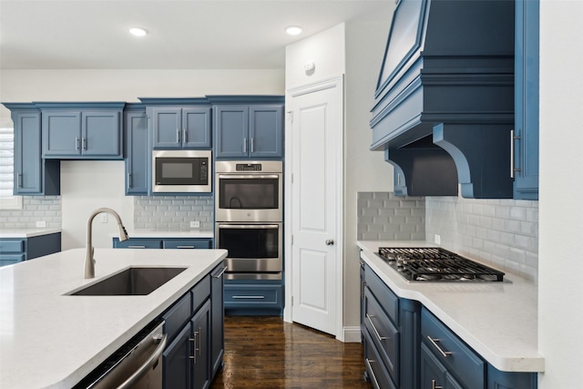 kitchen featuring a sink, light countertops, blue cabinets, and stainless steel appliances