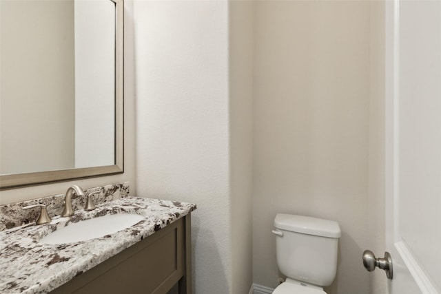 bathroom with toilet and vanity