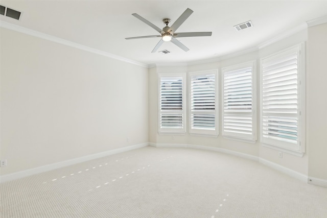 spare room with light carpet, baseboards, visible vents, and ornamental molding