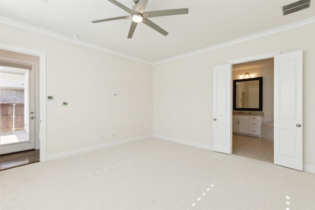 unfurnished bedroom with crown molding, baseboards, visible vents, and light carpet