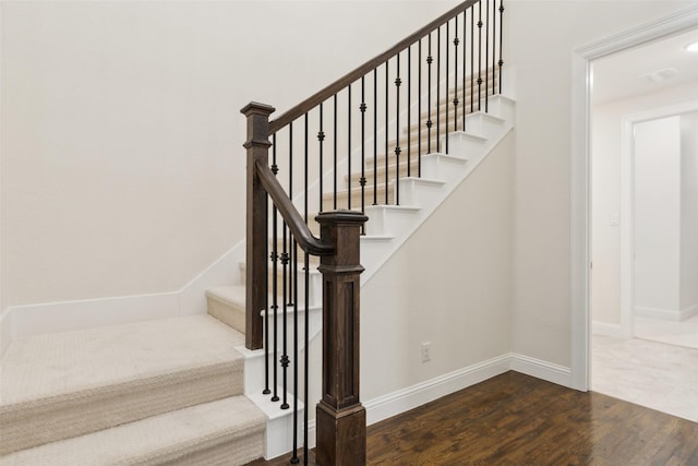 stairs with baseboards and wood finished floors