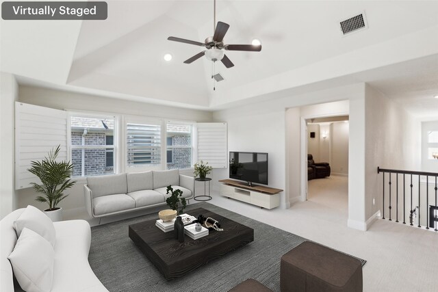 living room with visible vents, a ceiling fan, baseboards, carpet floors, and lofted ceiling