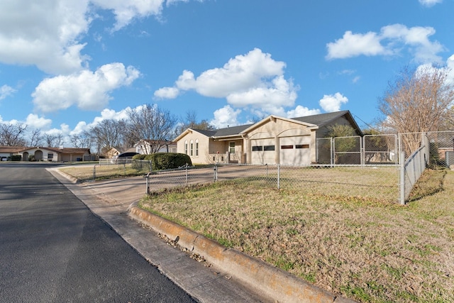 view of front of home with a gate, driveway, a garage, and fence