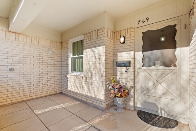 property entrance featuring brick siding