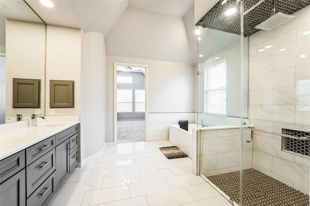 full bath featuring tile patterned flooring, lofted ceiling, a stall shower, a bath, and vanity