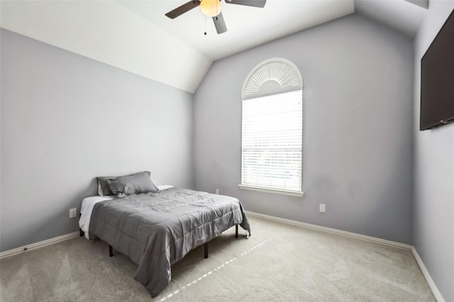 carpeted bedroom featuring vaulted ceiling, a ceiling fan, and baseboards