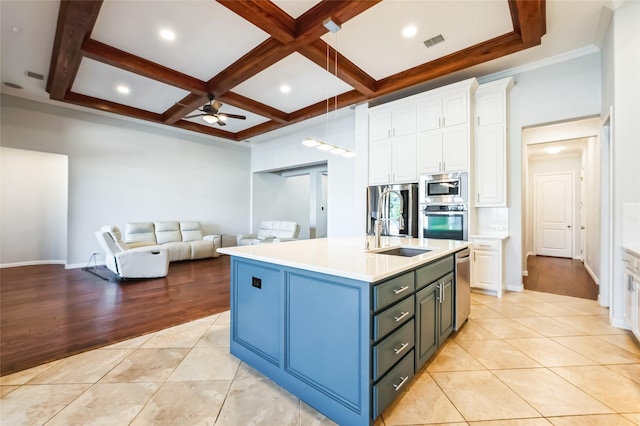 kitchen with visible vents, a sink, coffered ceiling, white cabinetry, and stainless steel appliances