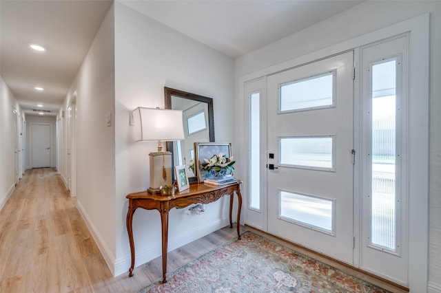 foyer featuring recessed lighting, light wood-type flooring, and baseboards