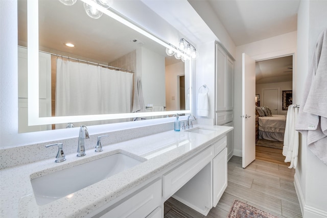 ensuite bathroom with double vanity, ensuite bathroom, and a sink