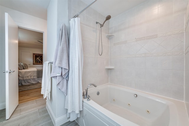 bathroom with ensuite bathroom, a combined bath / shower with jetted tub, and wood finished floors