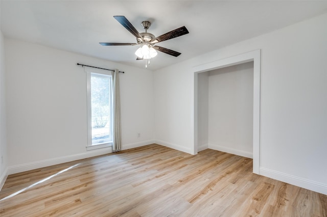 unfurnished room with ceiling fan, baseboards, and wood finished floors