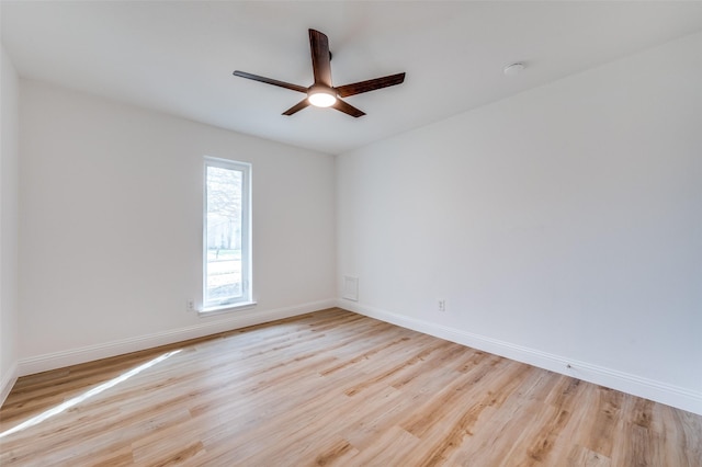 unfurnished room featuring ceiling fan, baseboards, and wood finished floors