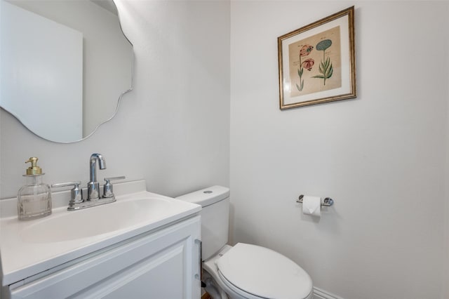 bathroom featuring toilet and vanity