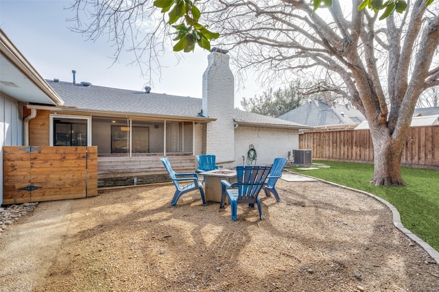 view of yard with central AC unit, an outdoor fire pit, a patio, and fence