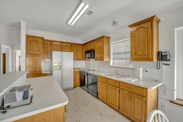 kitchen featuring a sink, white refrigerator with ice dispenser, black microwave, dishwashing machine, and light floors