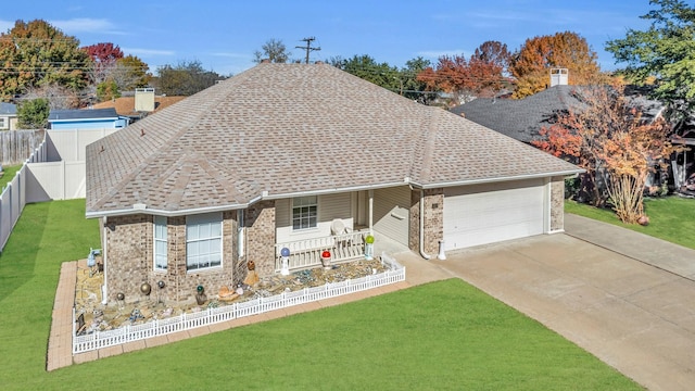 ranch-style house featuring a front lawn, an attached garage, fence, and brick siding