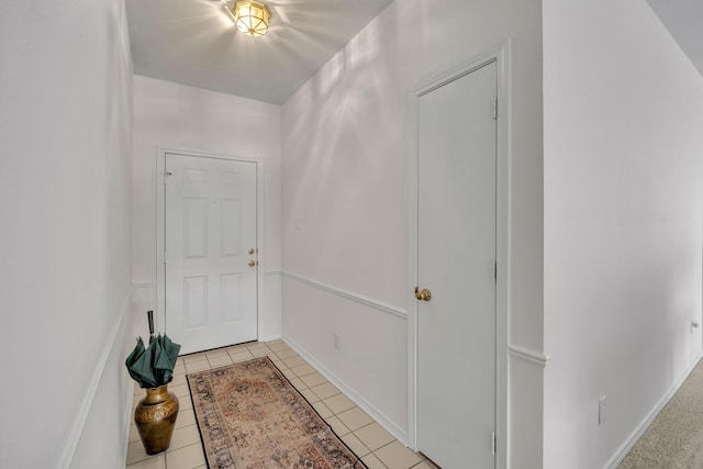 interior space with light tile patterned floors and baseboards