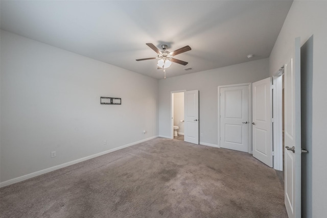 unfurnished bedroom featuring carpet flooring, a ceiling fan, baseboards, and ensuite bathroom