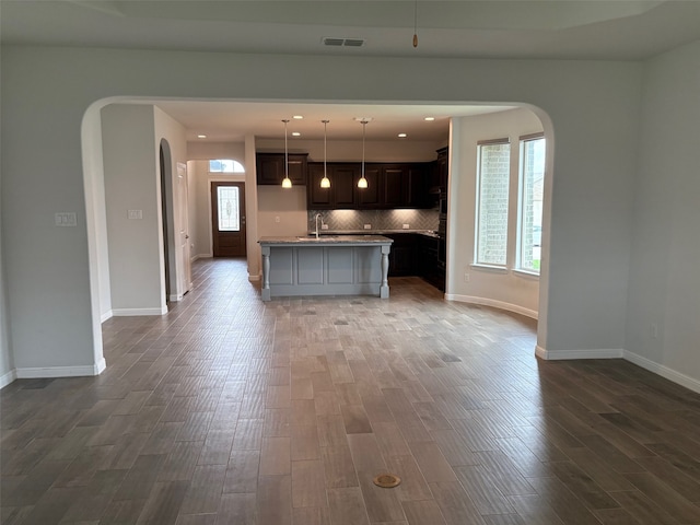 2420 Red Draw Rd, Fort Worth, TX 76177 - kitchen with a sink, arched walkways, baseboards, and dark wood-type flooring