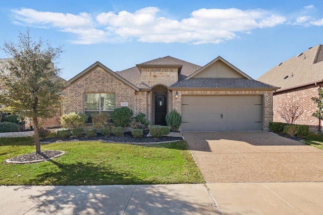 view of front of home featuring roof with shingles, concrete driveway, an attached garage, a front yard, and brick siding