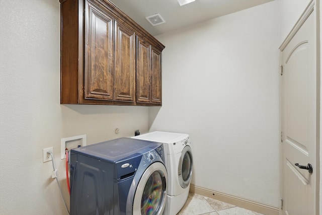 washroom with washing machine and clothes dryer, visible vents, baseboards, light tile patterned floors, and cabinet space