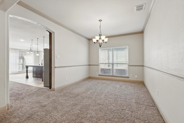 unfurnished room featuring a wealth of natural light, visible vents, light carpet, and an inviting chandelier