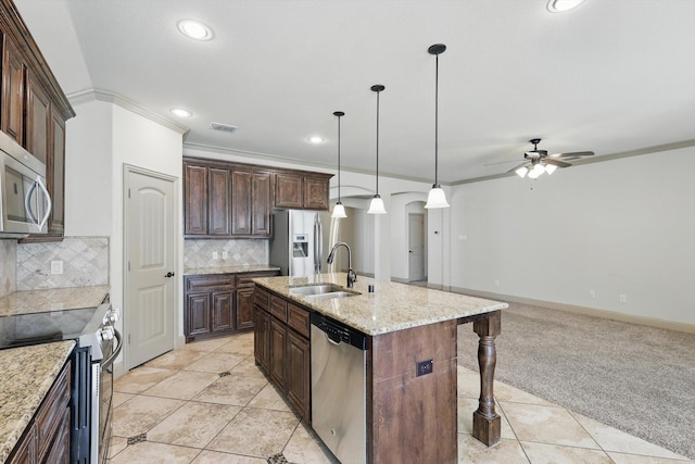 kitchen with visible vents, light carpet, ornamental molding, a sink, and stainless steel appliances